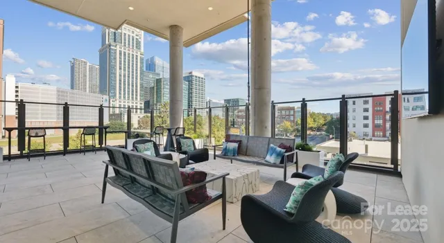 a living room with furniture and floor to ceiling windows