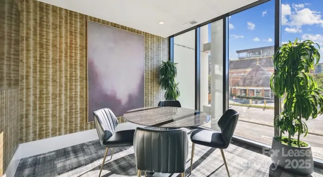a view of a dining room with furniture and window