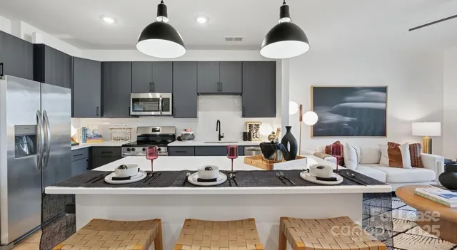 a kitchen with a refrigerator and a stove top oven