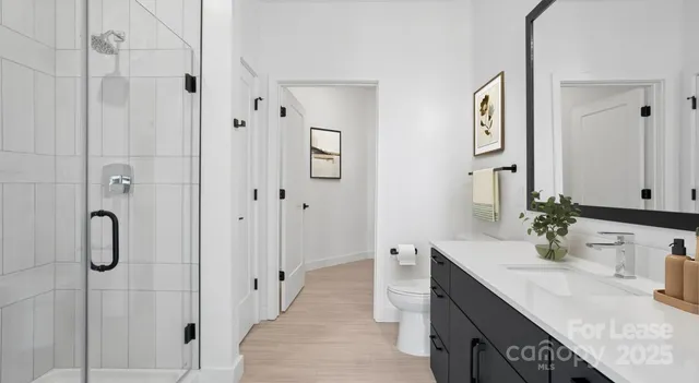 a spacious bathroom with a double vanity sink mirror and shower