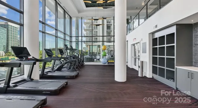 a view of a living room with furniture and floor to ceiling window