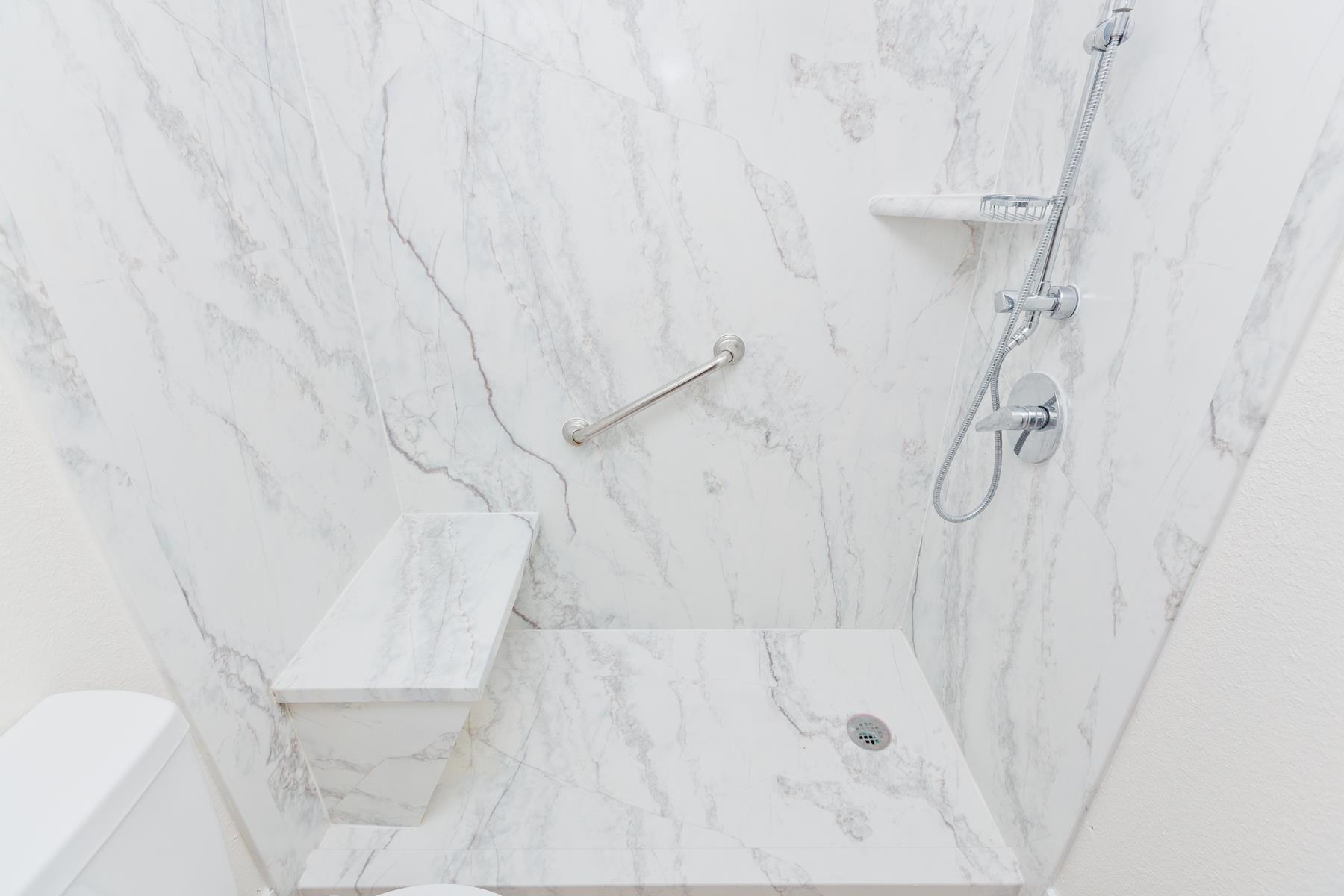 634 1/2 Colony Road Clifton, CO 81520 - Photo 22 of 42 a bathroom with a white shower and a glass door shower