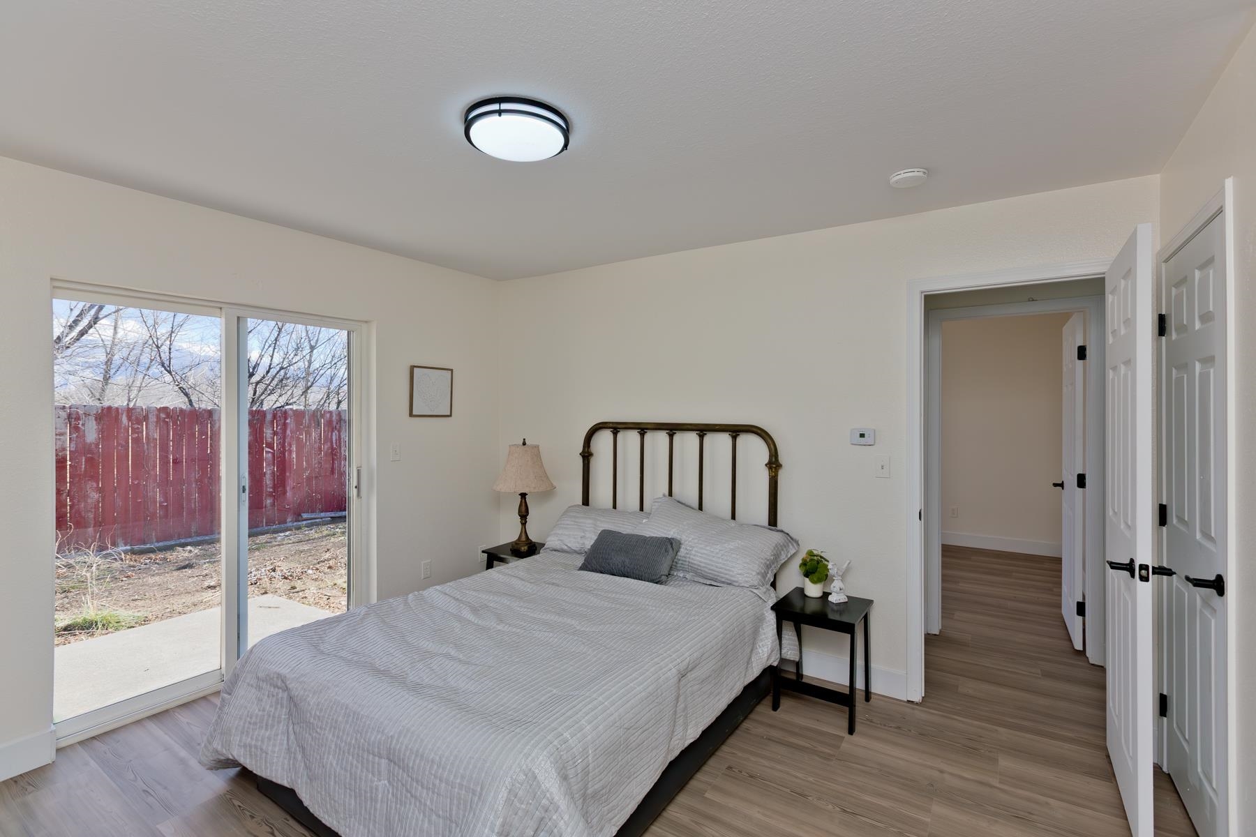 634 1/2 Colony Road Clifton, CO 81520 - Photo 25 of 42 a bedroom with a bed and a large window