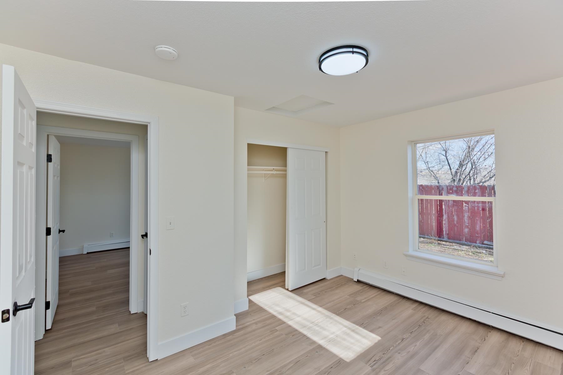 634 1/2 Colony Road Clifton, CO 81520 - Photo 32 of 42 an empty room with wooden floor closet and windows