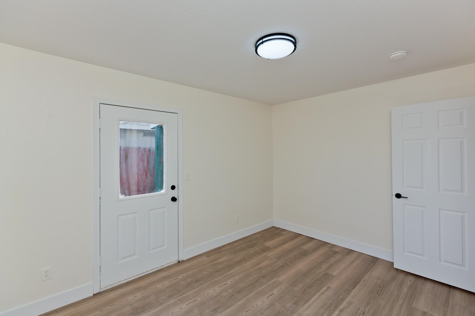 634 1/2 Colony Road Clifton, CO 81520 - Photo 34 of 42 an empty room with wooden floor and mirror
