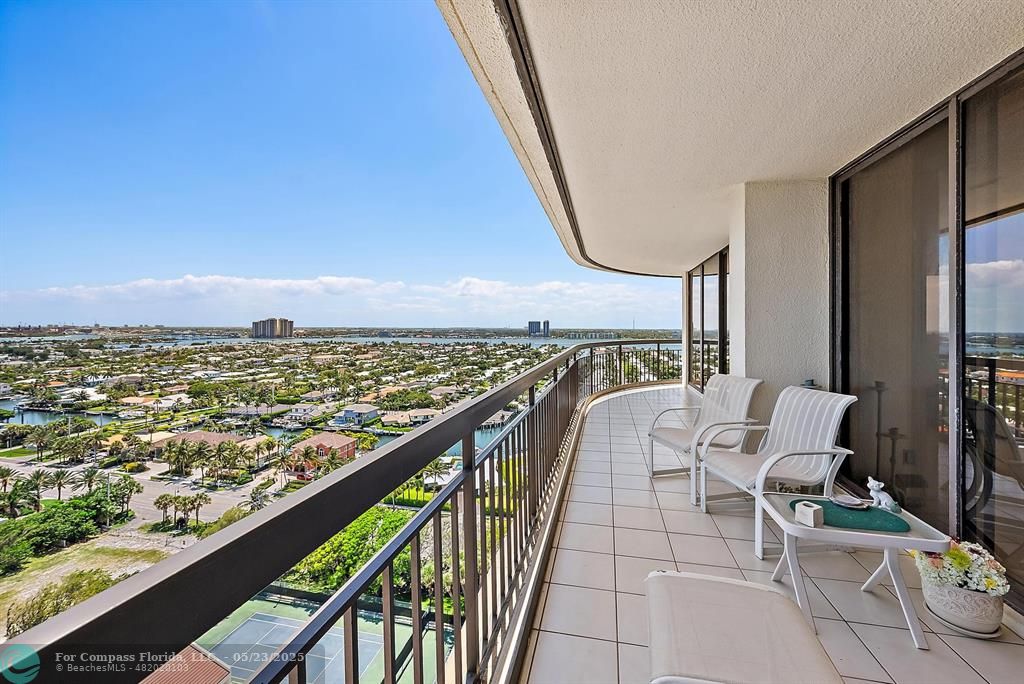 4100 North Ocean Drive, Unit 1804 Riviera Beach, FL 33404 - Photo 13 of 30 a balcony with wooden floor table and chairs