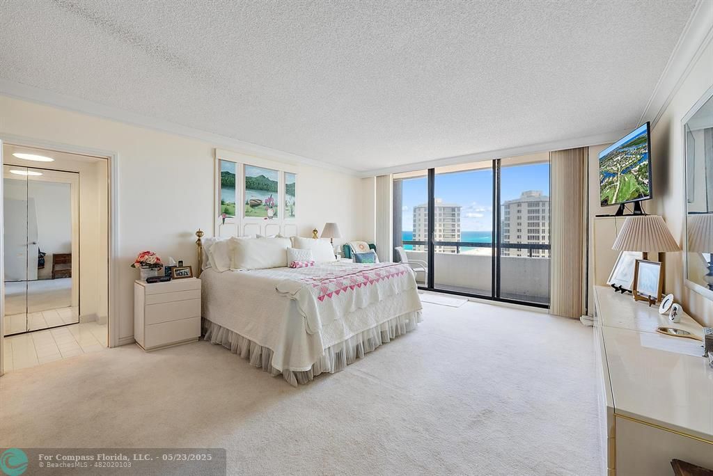 4100 North Ocean Drive, Unit 1804 Riviera Beach, FL 33404 - Photo 17 of 30 a spacious bedroom with a bed and a large window