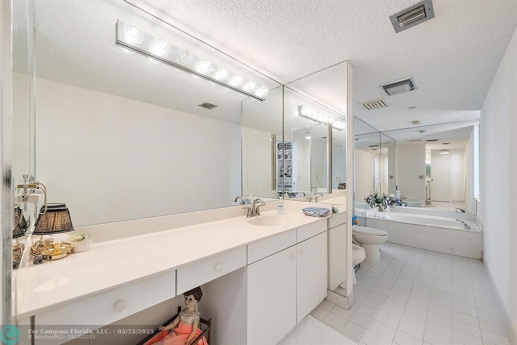 4100 North Ocean Drive, Unit 1804 Riviera Beach, FL 33404 - Photo 18 of 30 a bathroom with a double vanity sink a bathtub and shower