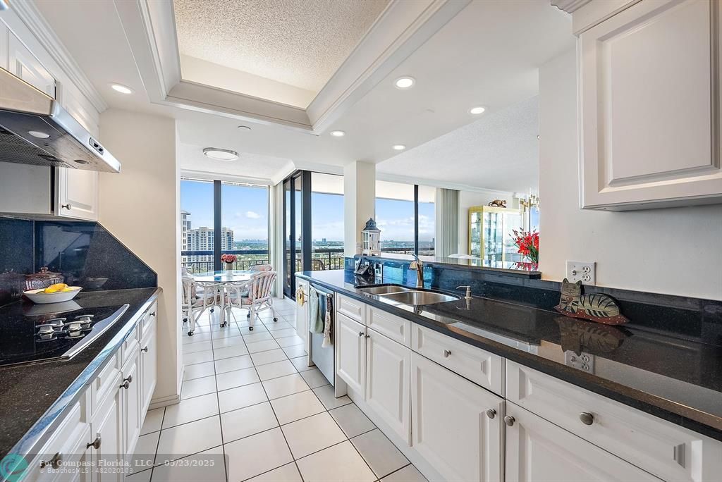 4100 North Ocean Drive, Unit 1804 Riviera Beach, FL 33404 - Photo 7 of 30 a kitchen with stainless steel appliances a sink stove and cabinets