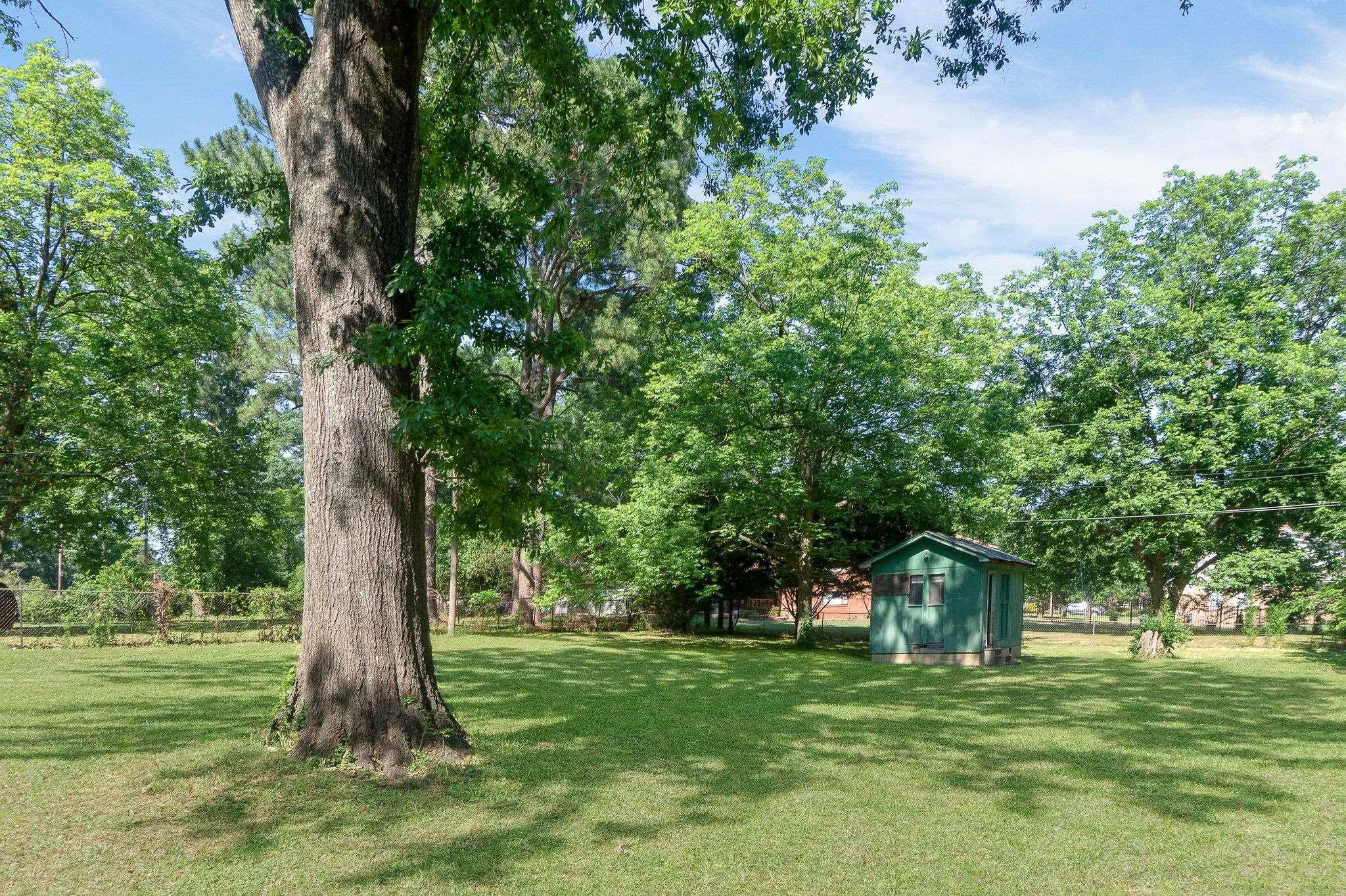 4506 Faronia Road Memphis, TN 38116 - Photo 14 of 15 View of yard featuring view of scattered trees and a shed