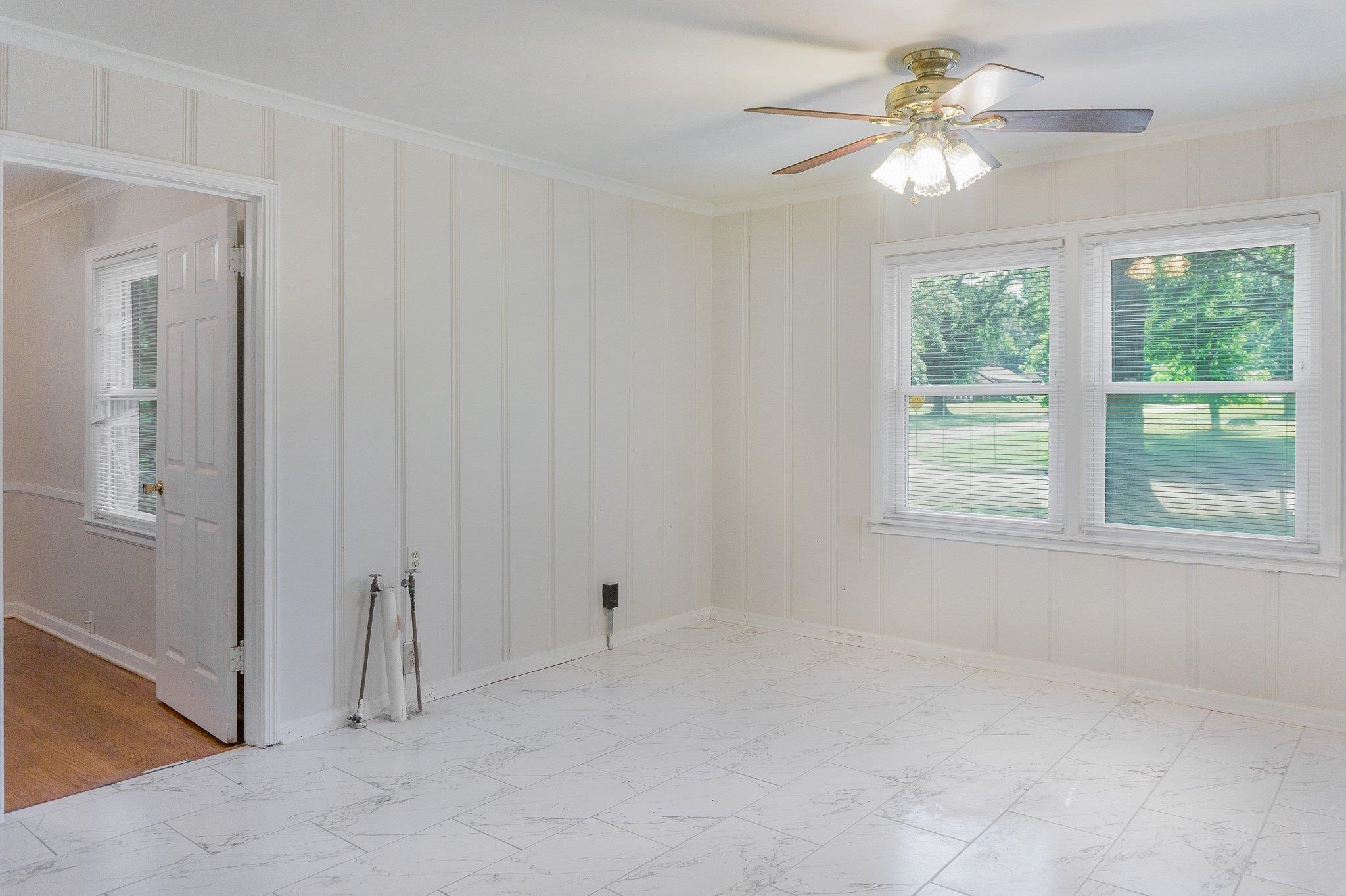 4506 Faronia Road Memphis, TN 38116 - Photo 3 of 15 Unfurnished room with crown molding, plenty of natural light, and a ceiling fan