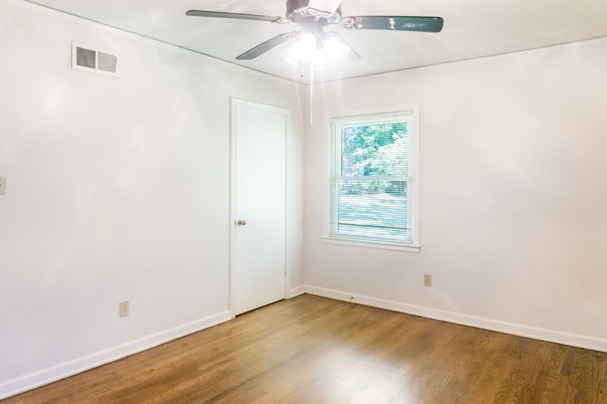 4506 Faronia Road Memphis, TN 38116 - Photo 5 of 15 Unfurnished room with wood finished floors and a ceiling fan
