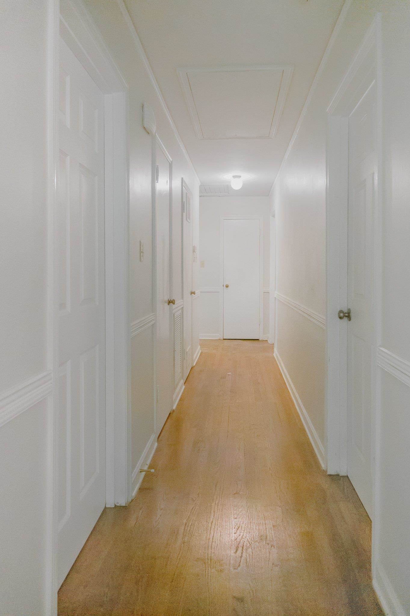 4506 Faronia Road Memphis, TN 38116 - Photo 9 of 15 Hallway featuring light wood finished floors and attic access
