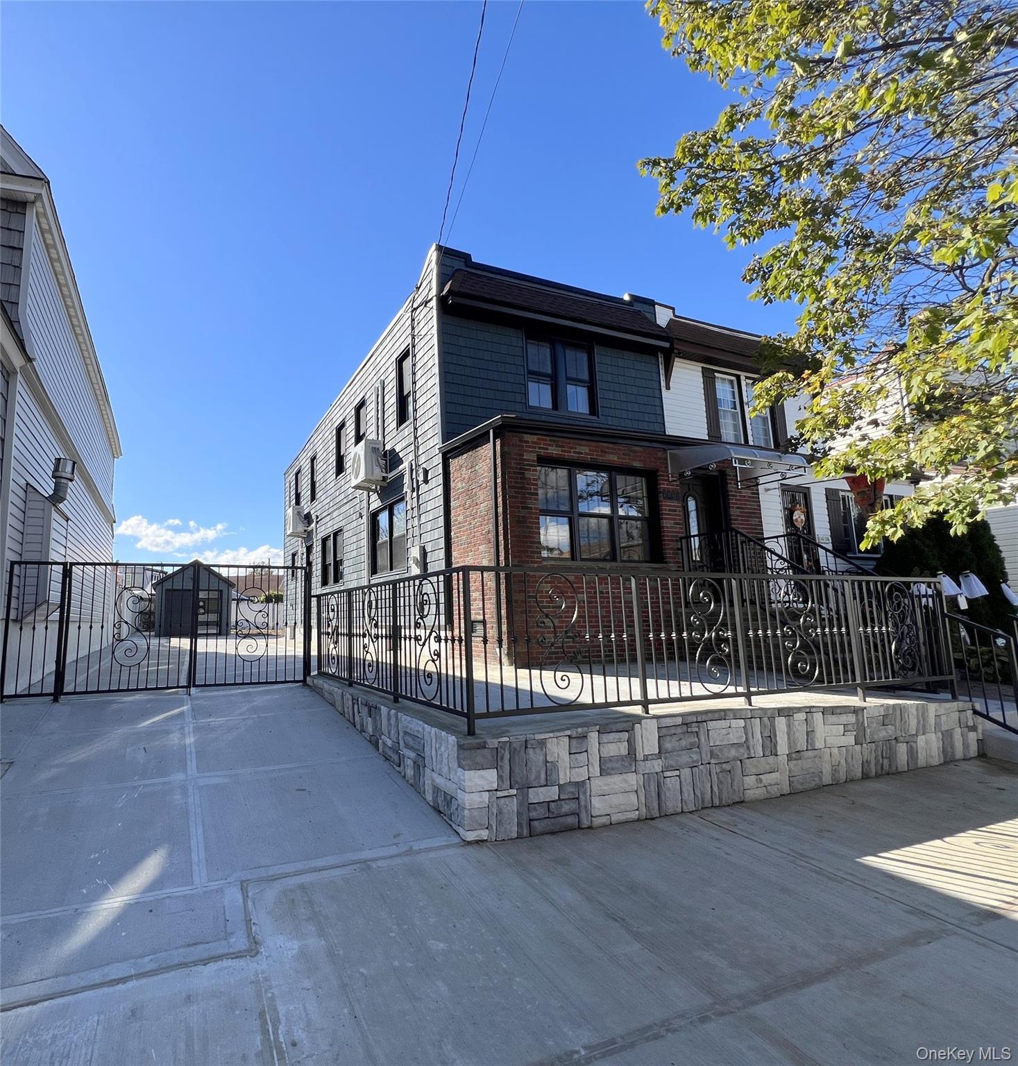 a view of a house with a small yard and wooden fence