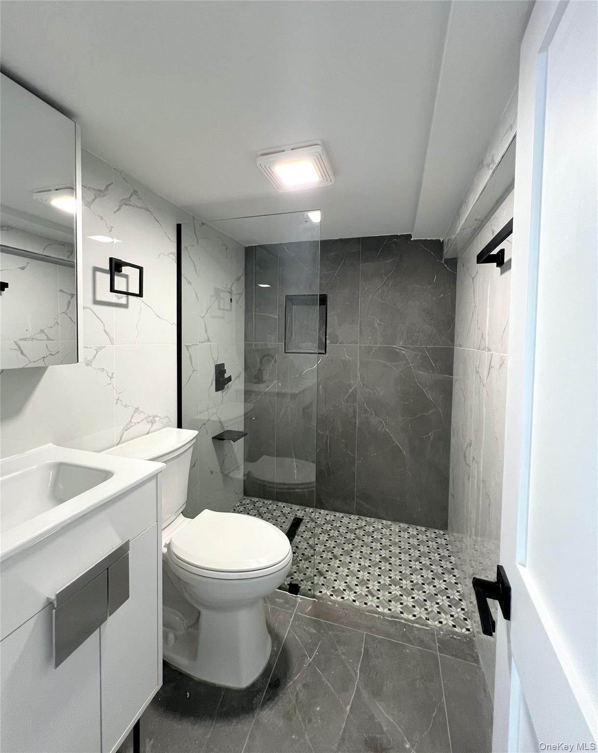 66-08 73rd Place Queens, NY 11379 - Photo 12 of 17 a bathroom with a sink toilet and shower