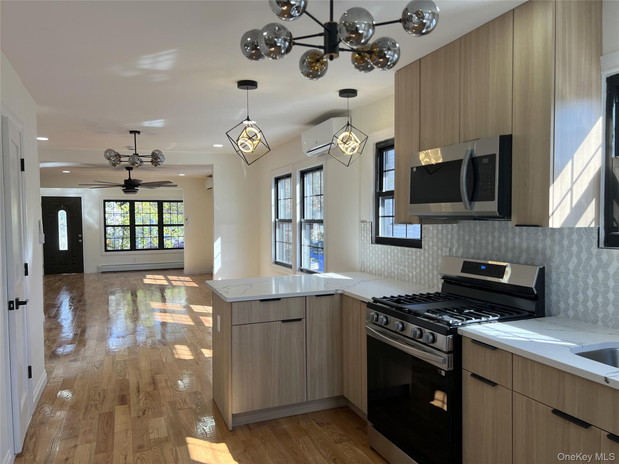 66-08 73rd Place Queens, NY 11379 - Photo 2 of 17 a kitchen with a sink stove and microwave