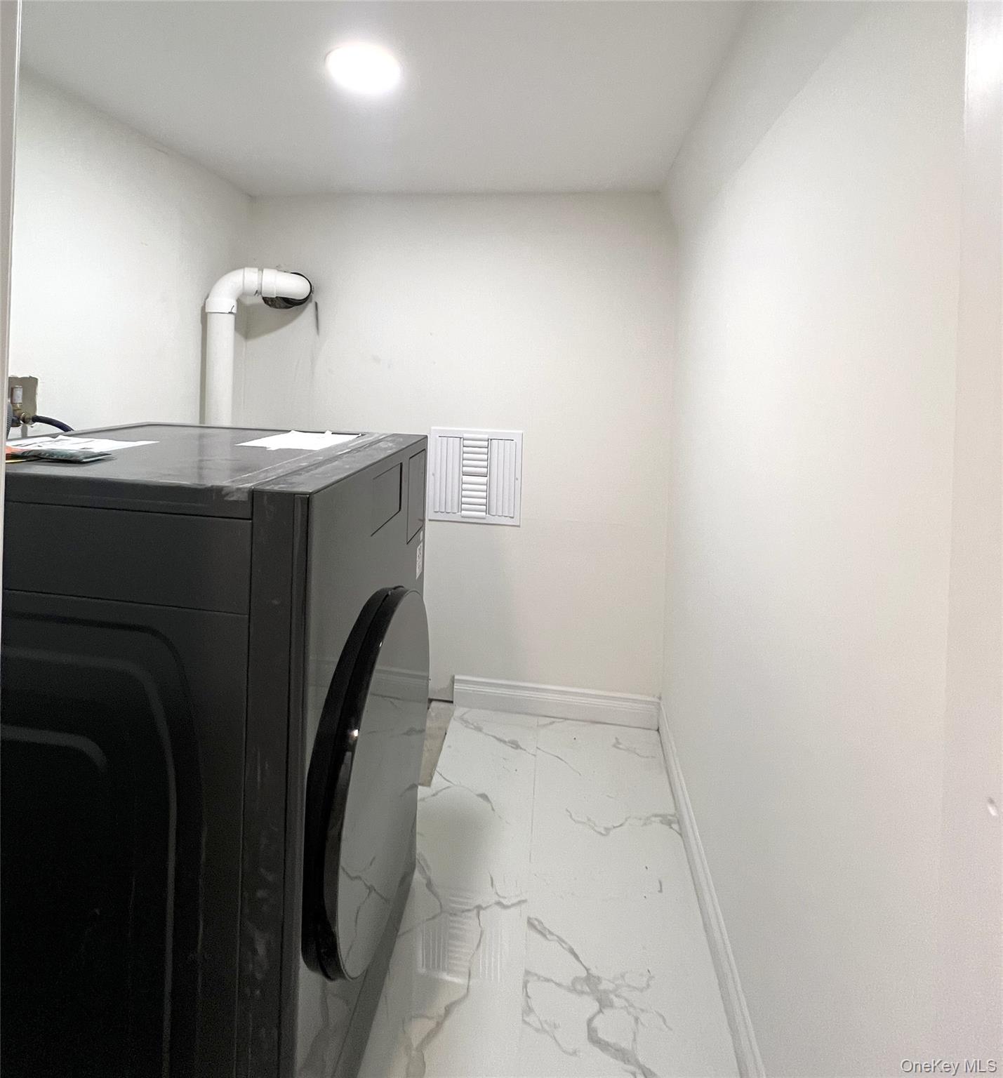 66-08 73rd Place Queens, NY 11379 - Photo 10 of 17 a utility room with dryer and washer