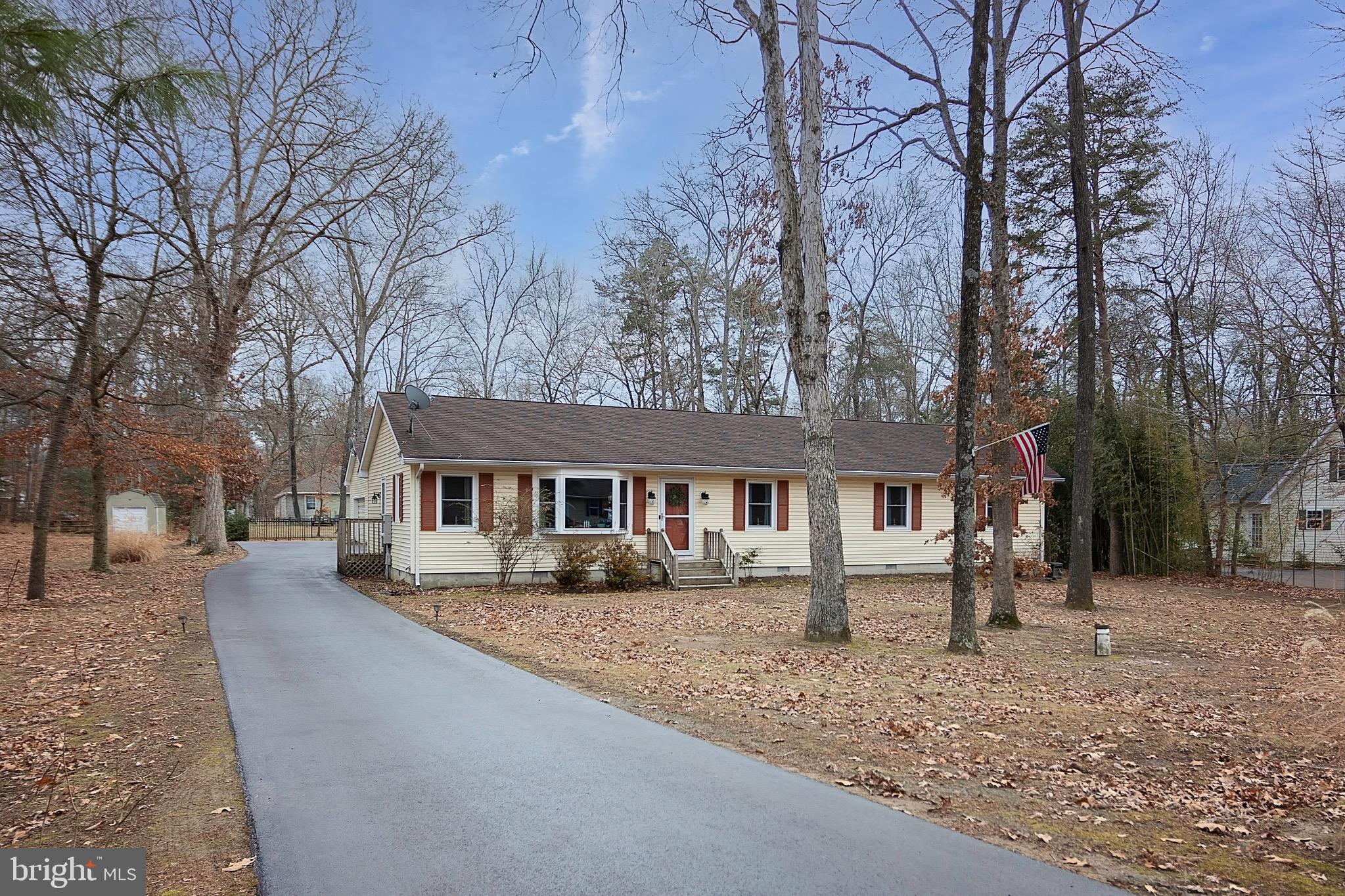 front view of a house with a yard covered with snow