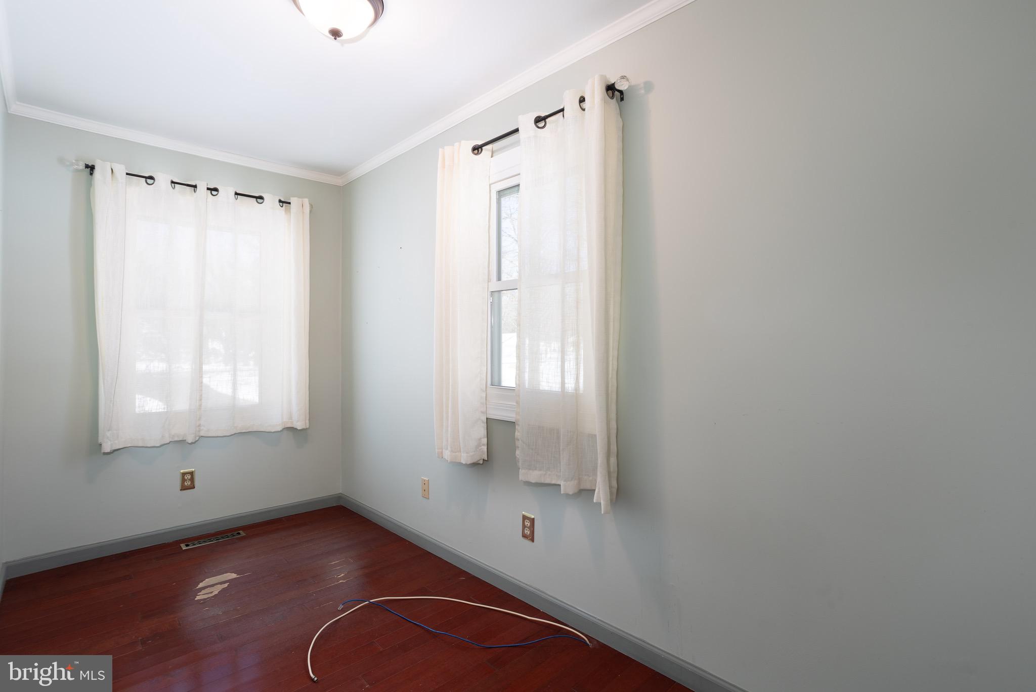 25999 Fox Grape Road Greensboro, MD 21639 - Photo 11 of 23 a view of an empty room with wooden floor and a window