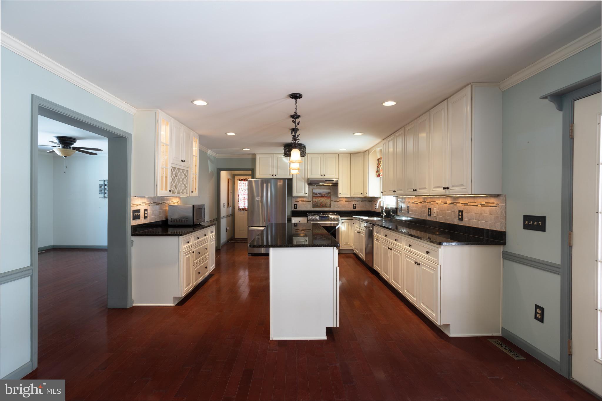 25999 Fox Grape Road Greensboro, MD 21639 - Photo 4 of 23 a kitchen with a sink cabinets and wooden floor