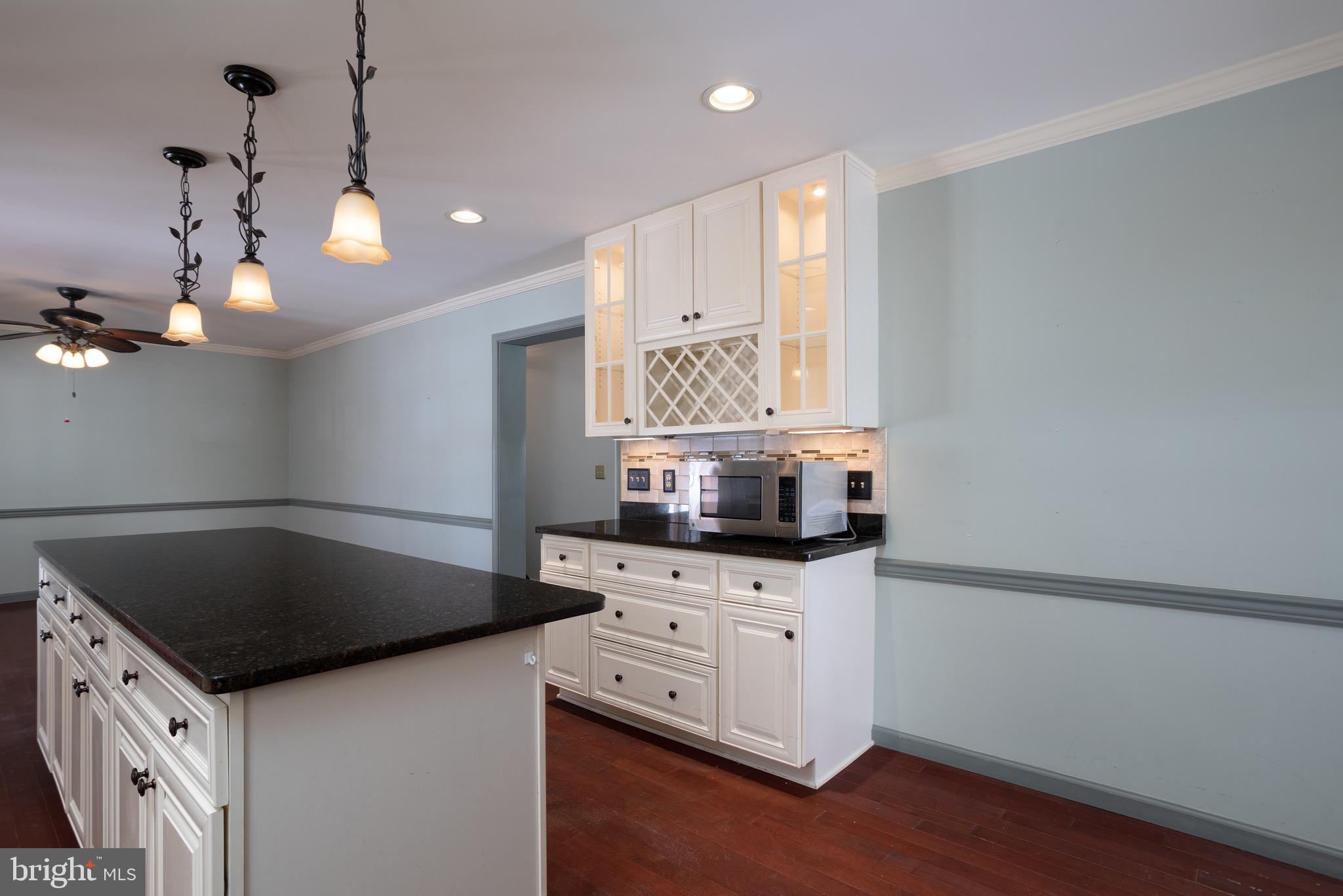 25999 Fox Grape Road Greensboro, MD 21639 - Photo 6 of 23 a kitchen with granite countertop a stove a sink and a microwave