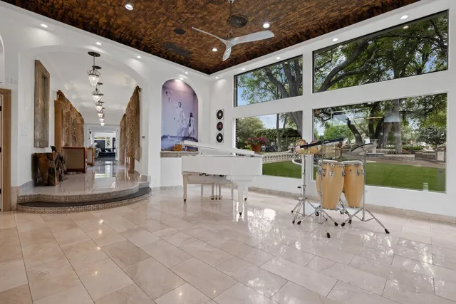 a view of a porch with chairs and backyard