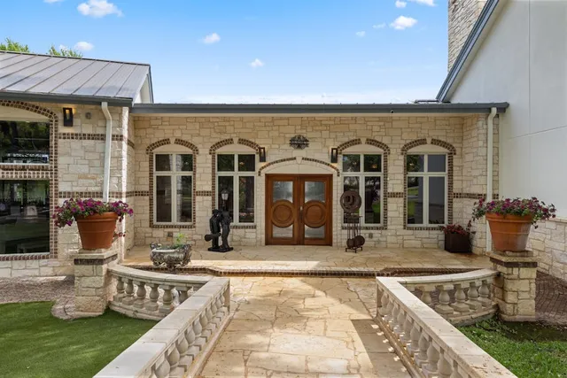 a front view of a house with glass top table and chairs