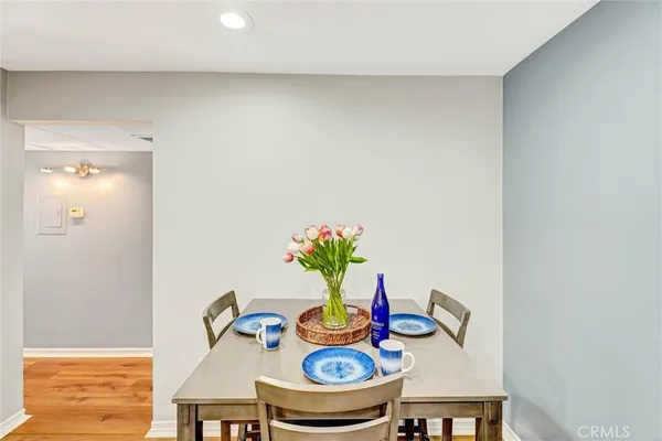 a table with chairs and a potted plant