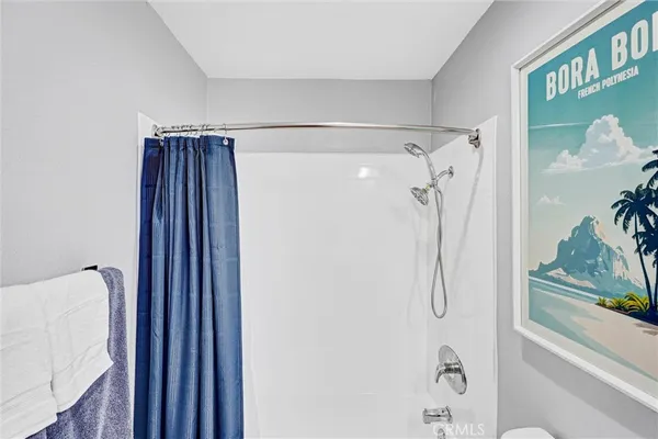 a bathroom with a shower and a glass door