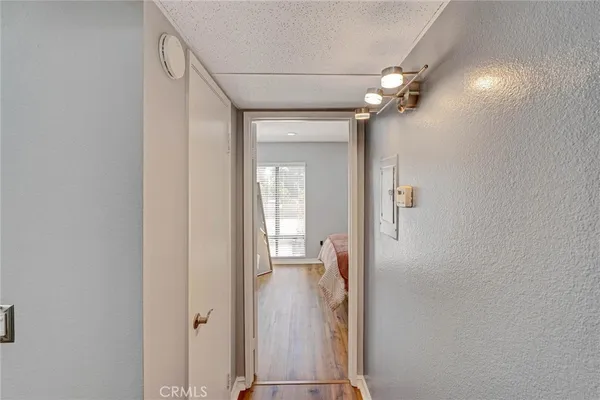 a view of a hallway with wooden floor