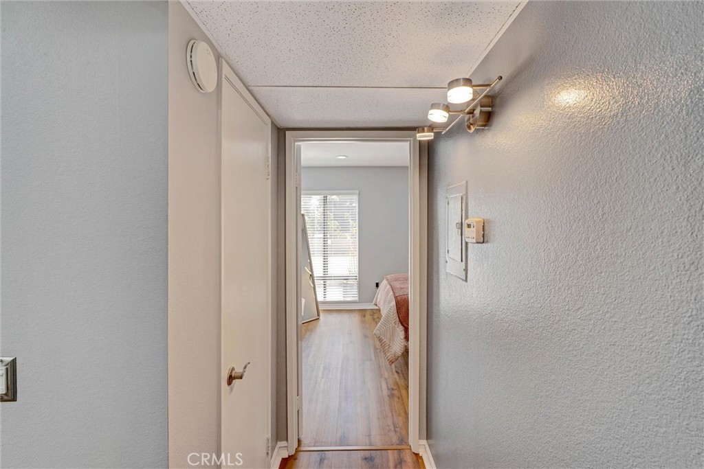 3010 Associated Road, Unit 133 Fullerton, CA 92835 - Photo 19 of 48 a view of a hallway with wooden floor