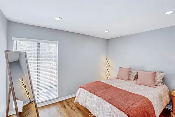 a bedroom with a bed and wooden floor