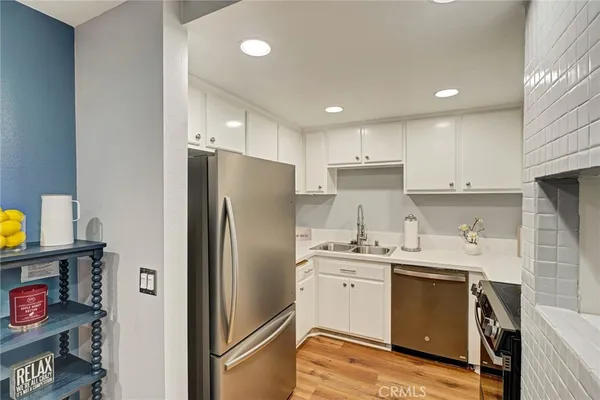 a kitchen with stainless steel appliances a refrigerator sink and cabinets
