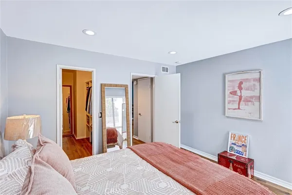 a bedroom with a bed and a lamp