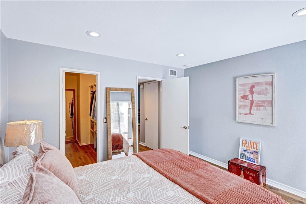 3010 Associated Road, Unit 133 Fullerton, CA 92835 - Photo 21 of 48 a bedroom with a bed and a lamp