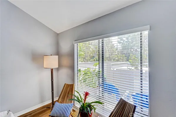 a view of a bedroom with furniture and wooden floor