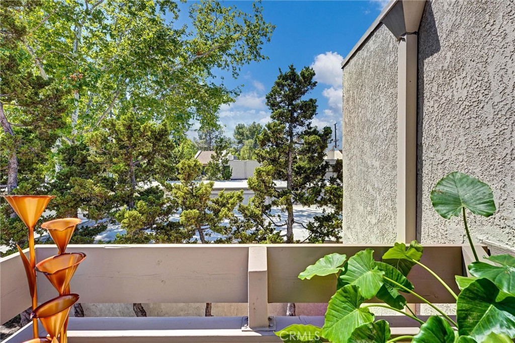 3010 Associated Road, Unit 133 Fullerton, CA 92835 - Photo 27 of 48 view of balcony with two plants and a bench