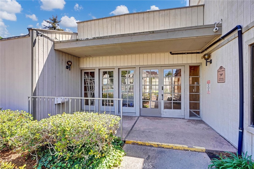 3010 Associated Road, Unit 133 Fullerton, CA 92835 - Photo 29 of 48 a front view of a house with a garden