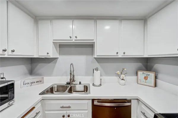 a kitchen with a sink and cabinets