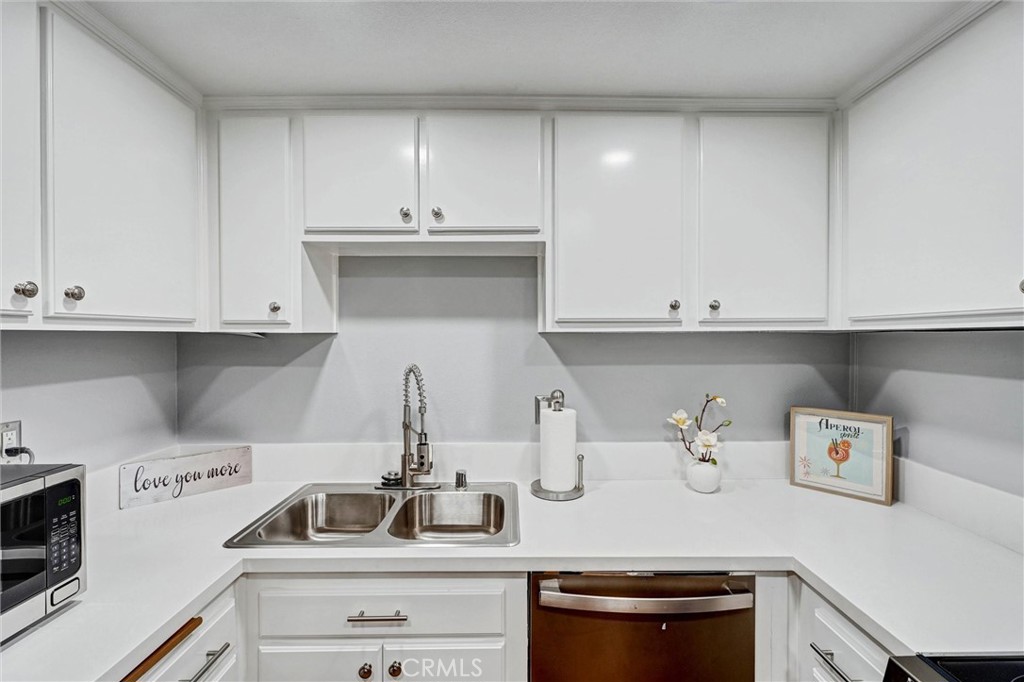 3010 Associated Road, Unit 133 Fullerton, CA 92835 - Photo 3 of 48 a kitchen with a sink and cabinets