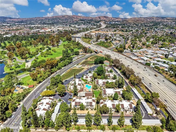 an aerial view of residential houses with city view