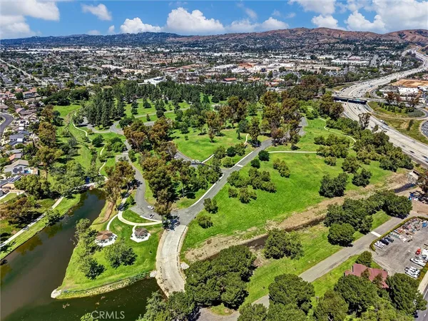 an aerial view of a residential houses with outdoor space and swimming pool