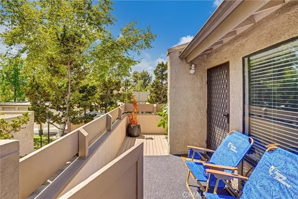 a view of a chair and tables in the balcony