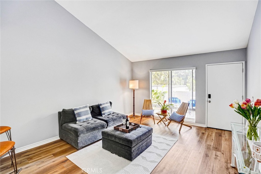 3010 Associated Road, Unit 133 Fullerton, CA 92835 - Photo 9 of 48 a living room with furniture and wooden floor