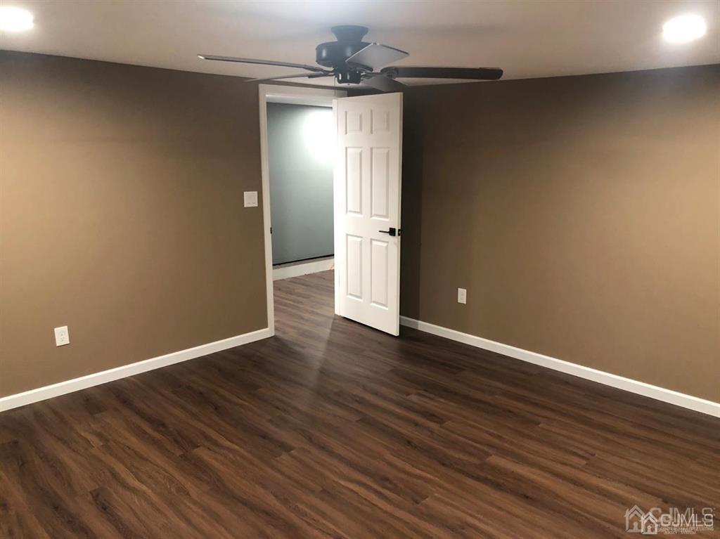 261 West Main Street Bound Brook, NJ 08805 - Photo 8 of 12 a view of an empty room with wooden floor and a window