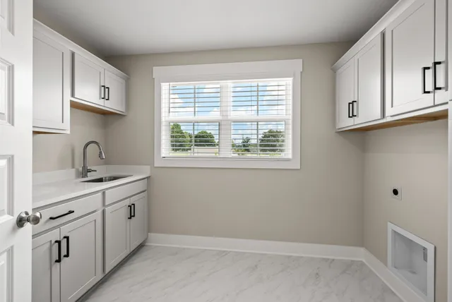 a kitchen with white cabinets and a sink