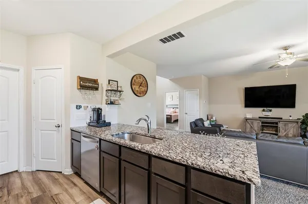 a kitchen with a sink and a stove top oven