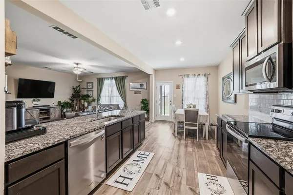 a kitchen with granite countertop lots of counter top space and stainless steel appliances