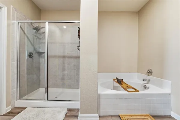 a bathroom with a tub and shower