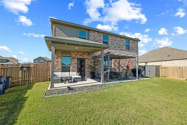 a view of a house with backyard porch and sitting area